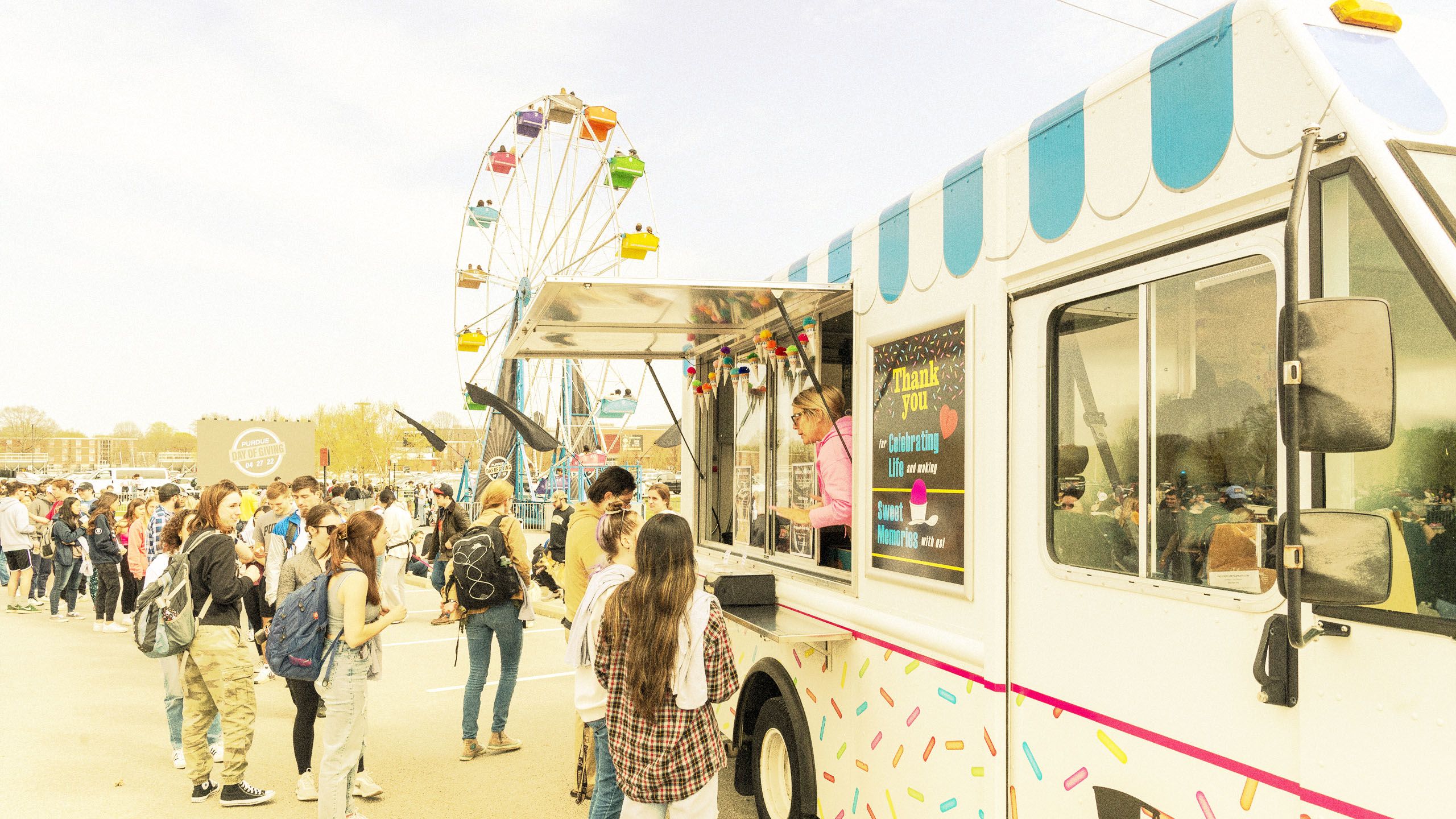 The image shows the Purdue Day of Giving carnival event