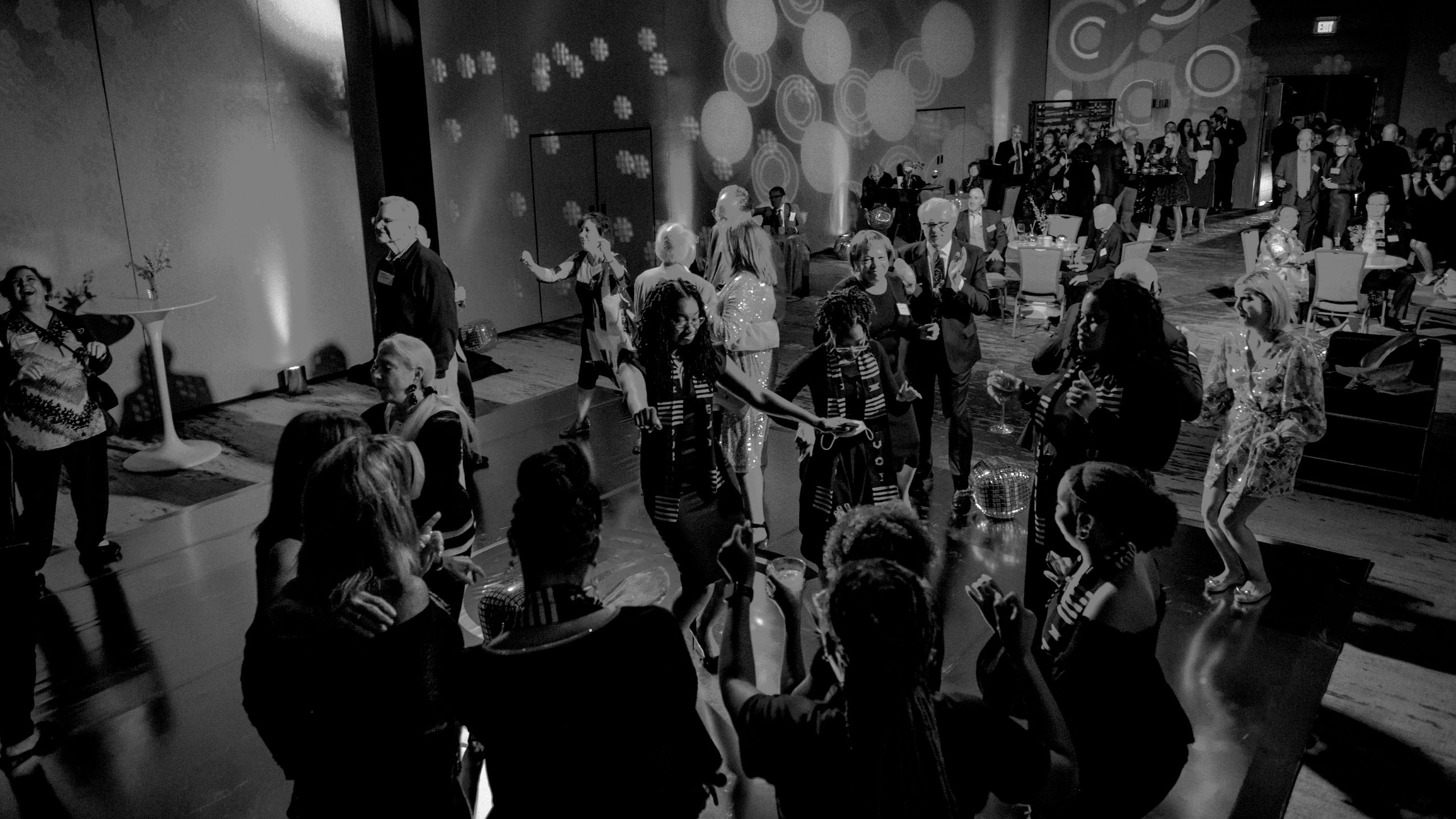The image shows people dancing at an event
