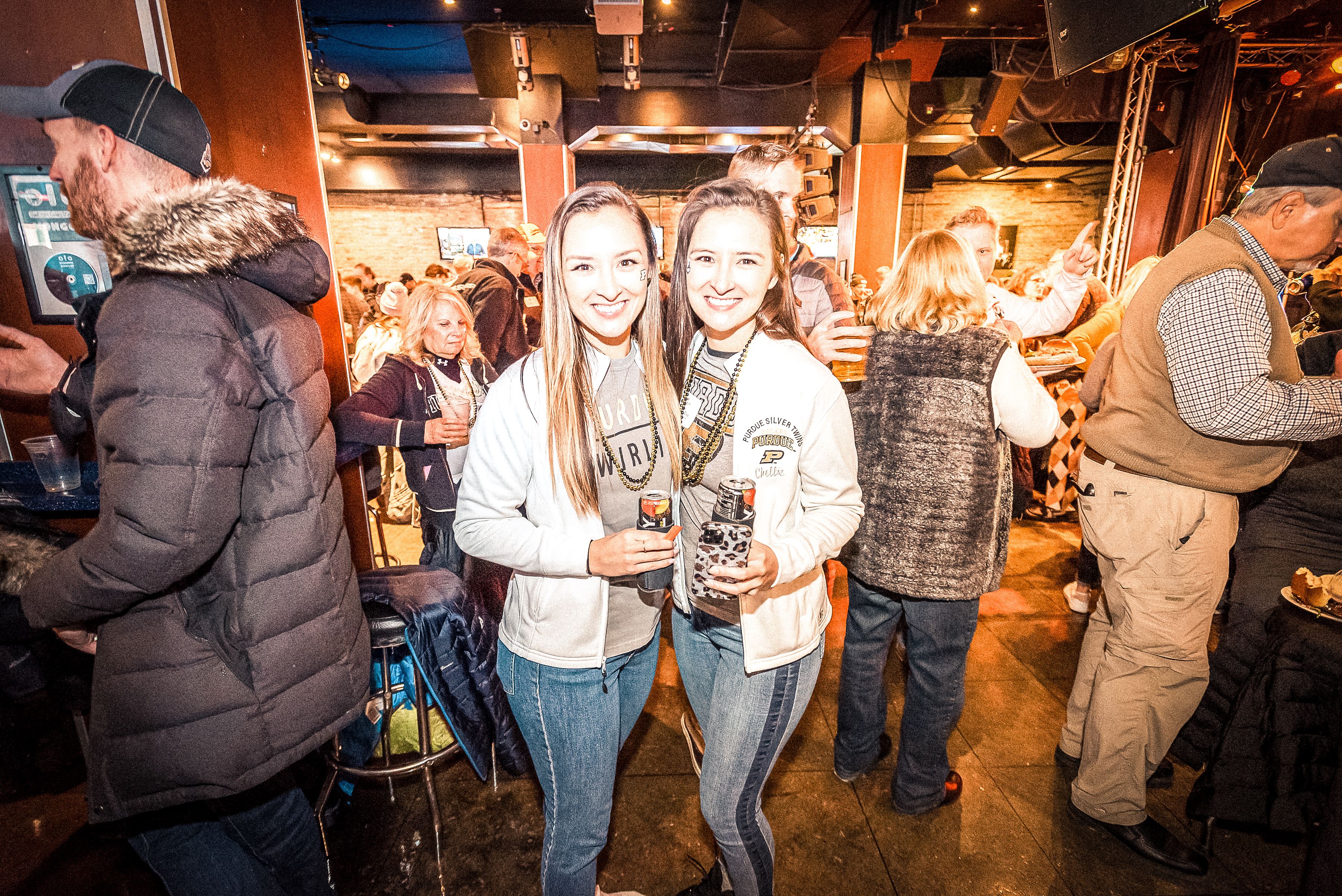 The image shows people at the Wrigley Field tailgate