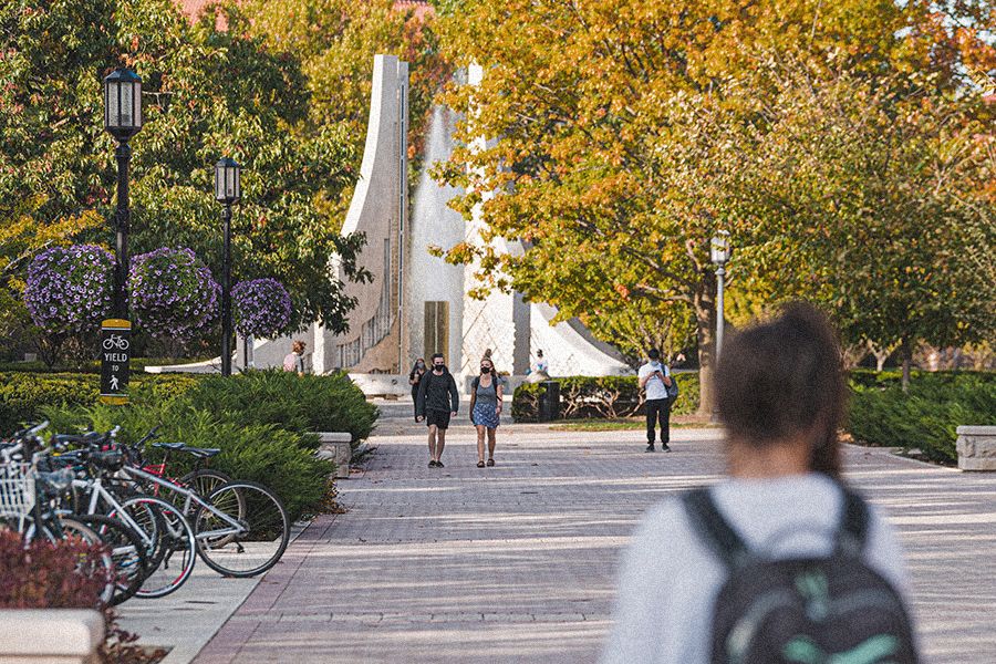 The image shows students walking on campus