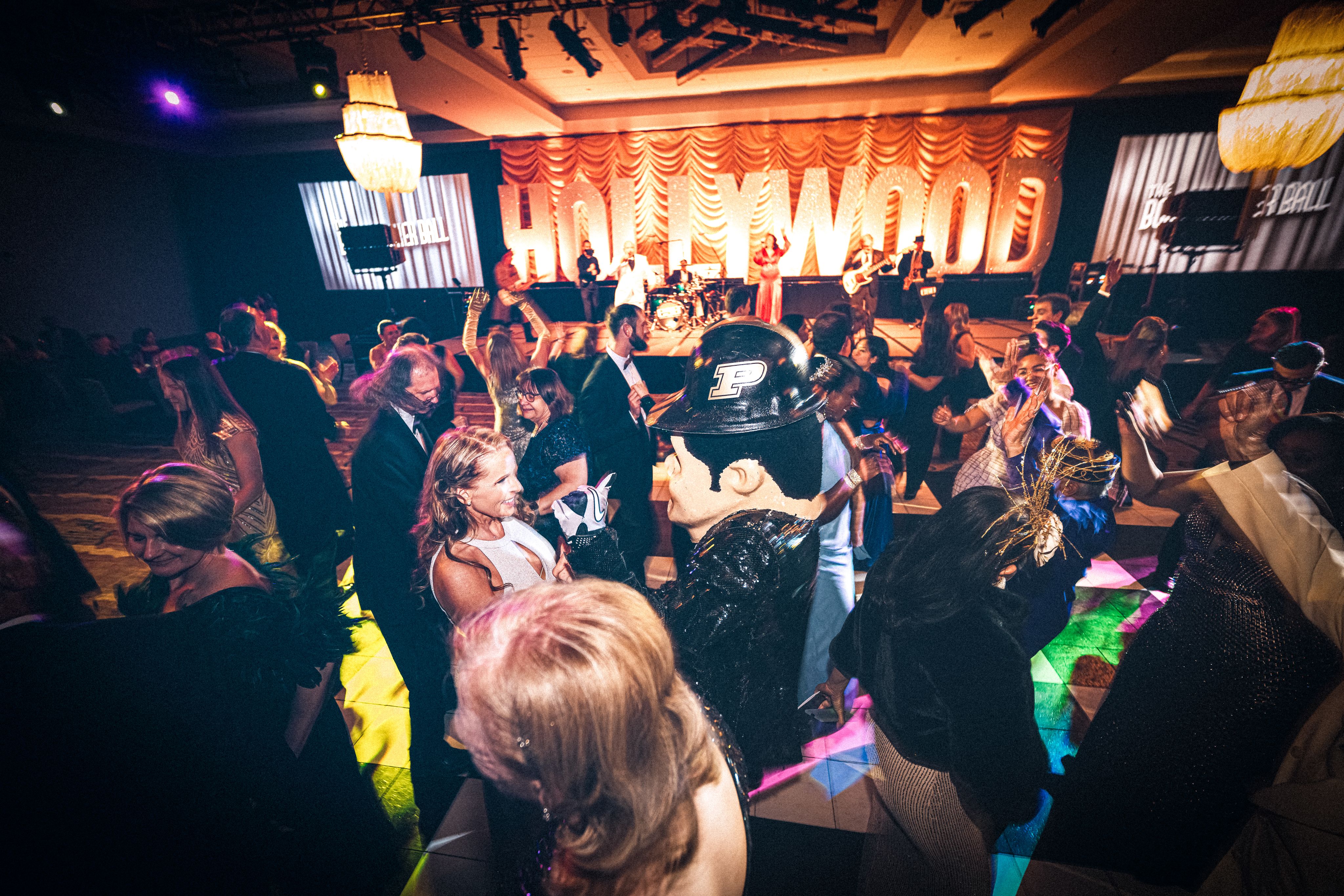 The image shows people dancing at the Boilermaker Ball