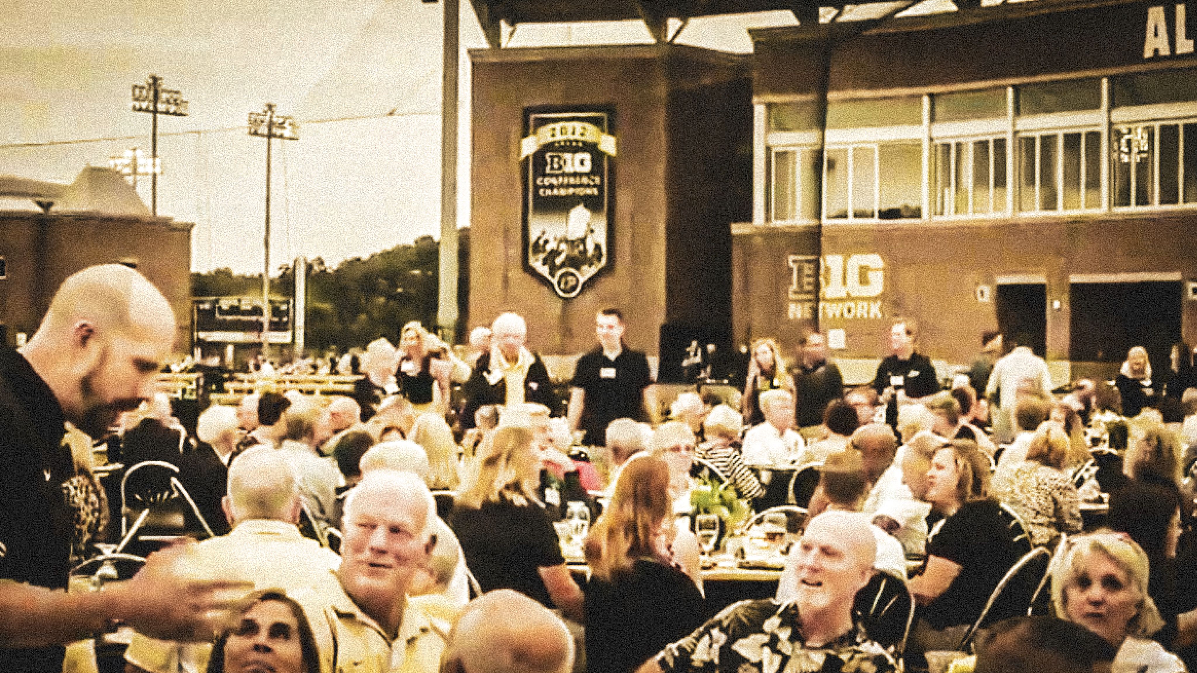 The image shows people seated at a dinner