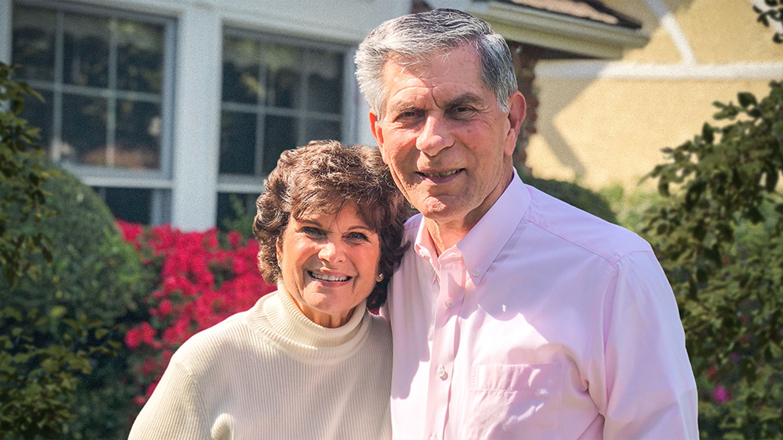 Nanette and Gerald Lyles stand in front of plants