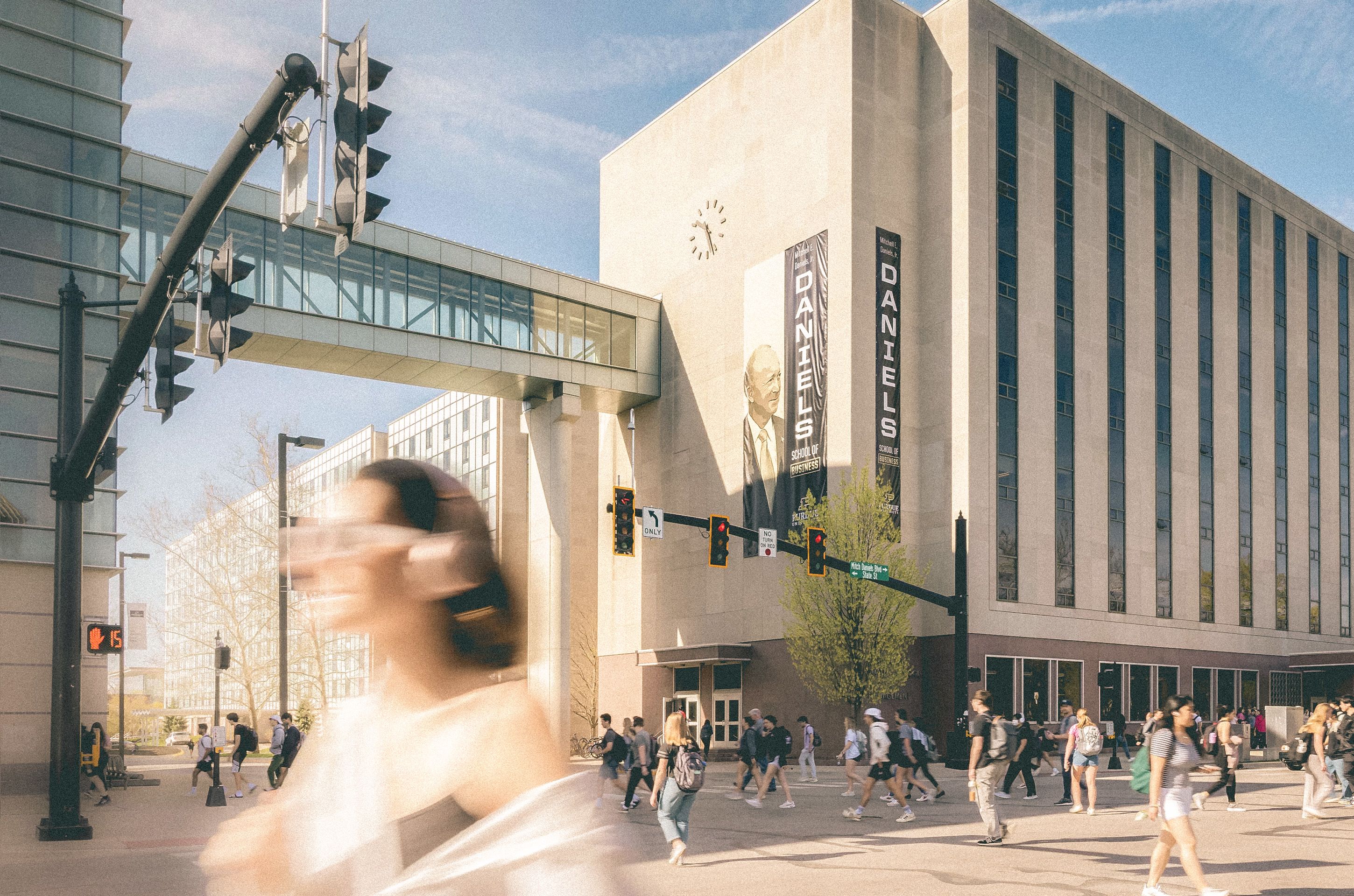 The Daniels School of Business with students standing outside on a sunny day