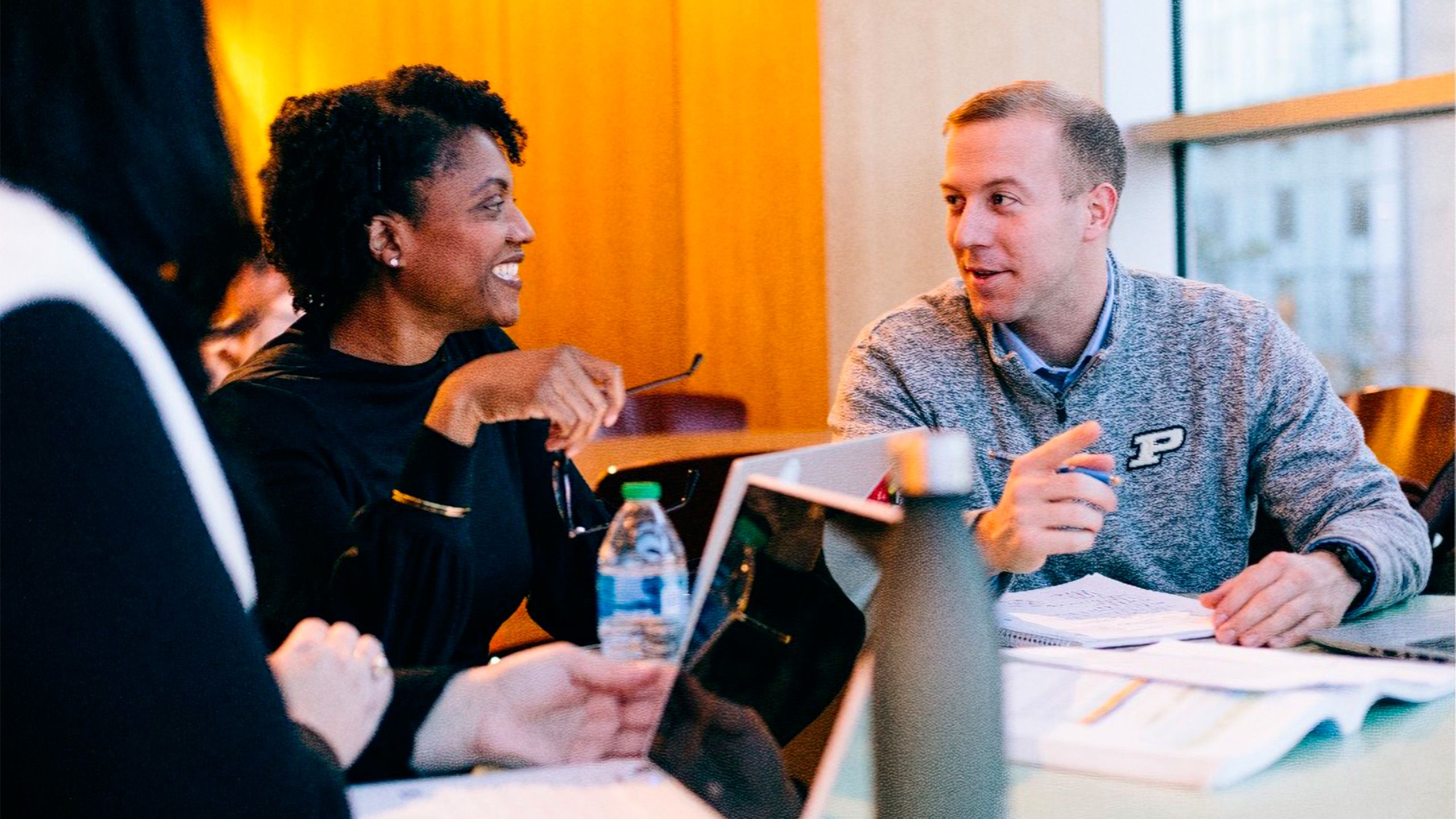 Two people sitting at a table and chatting