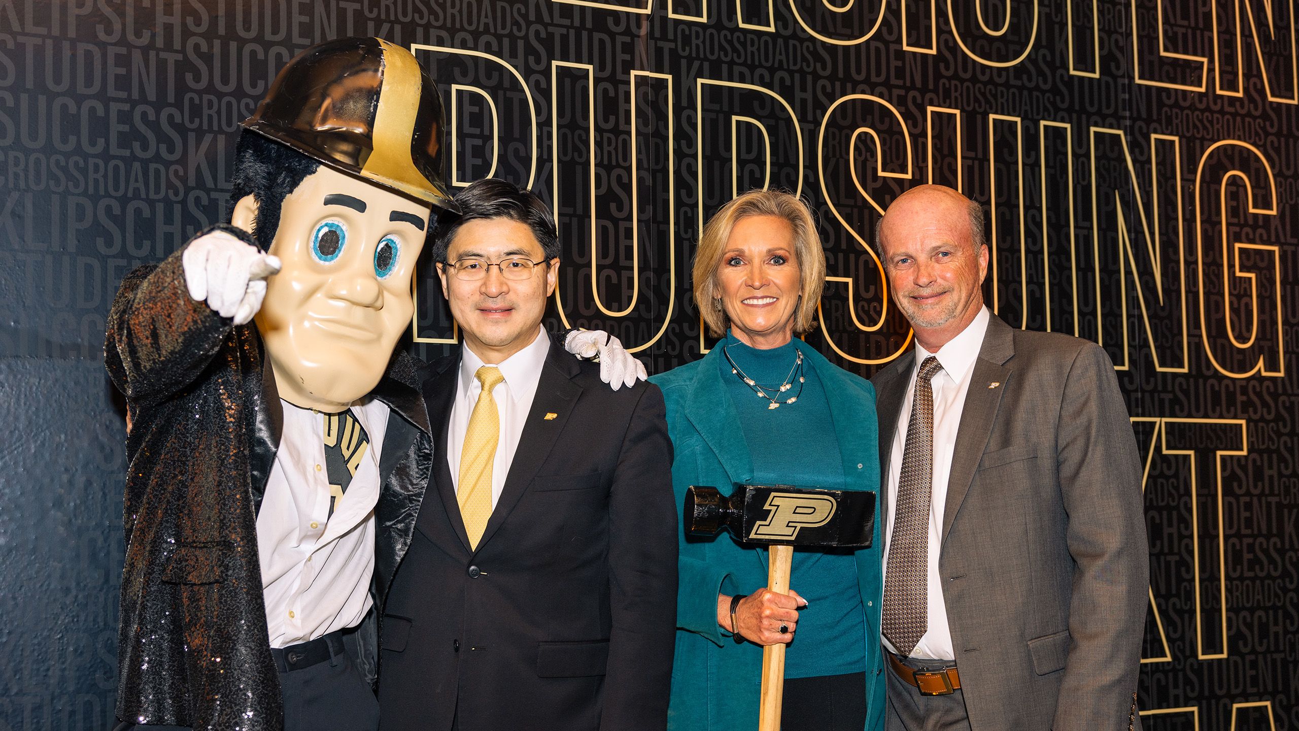 Purdue Pete poses with Mung Chiang and Paula and Mike Klipsch