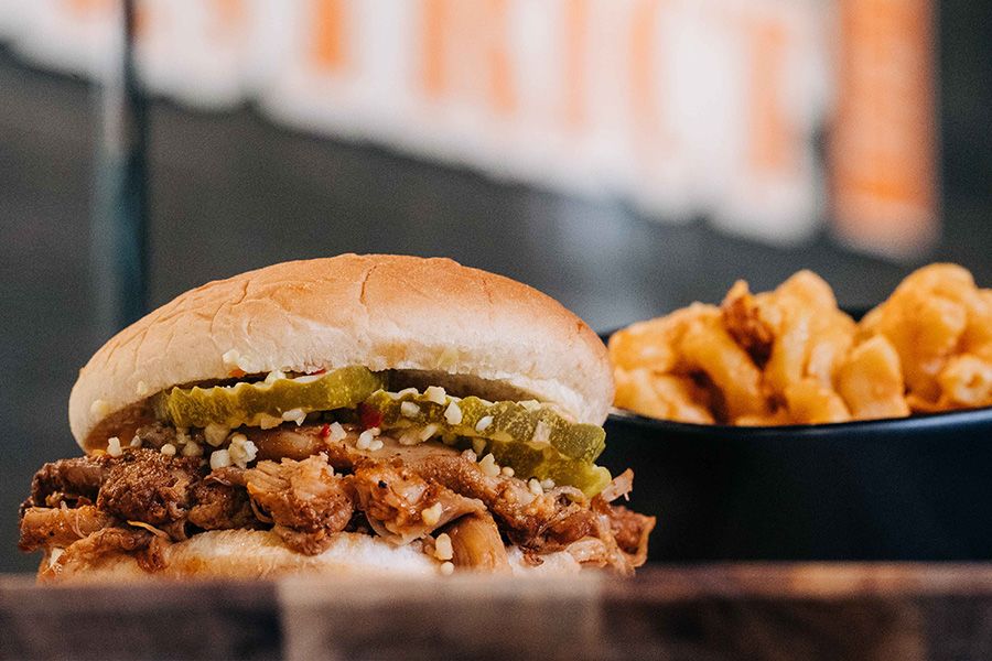A pulled pork sandwich with french fries