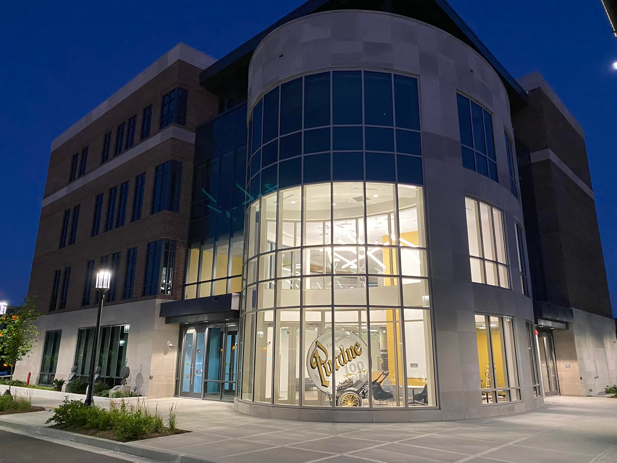 The image shows the exterior of Hagle Hall at dusk