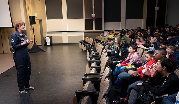 The images shows Sharon Hagle and schoolchildren