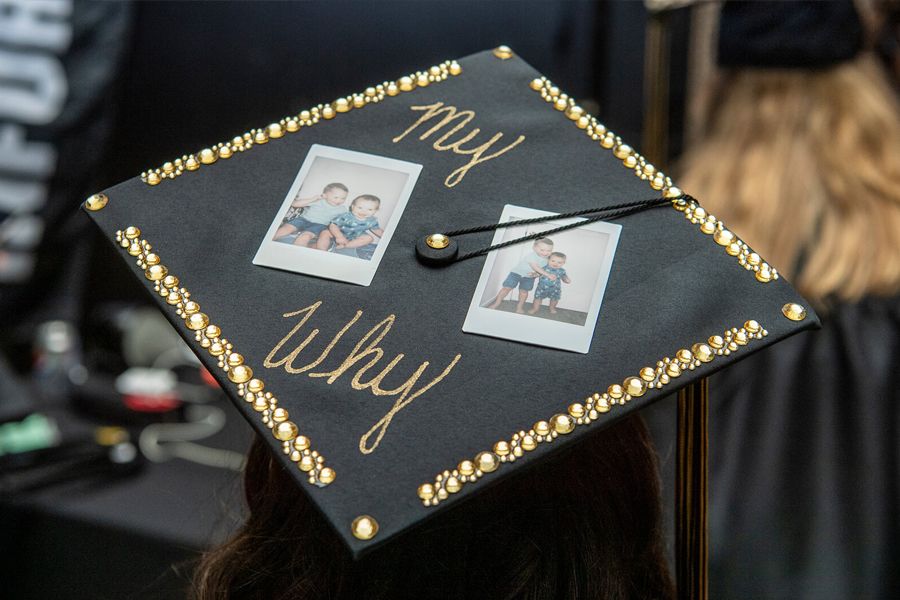 The image shows a mortar board that says "My Why" and that features photos of two children