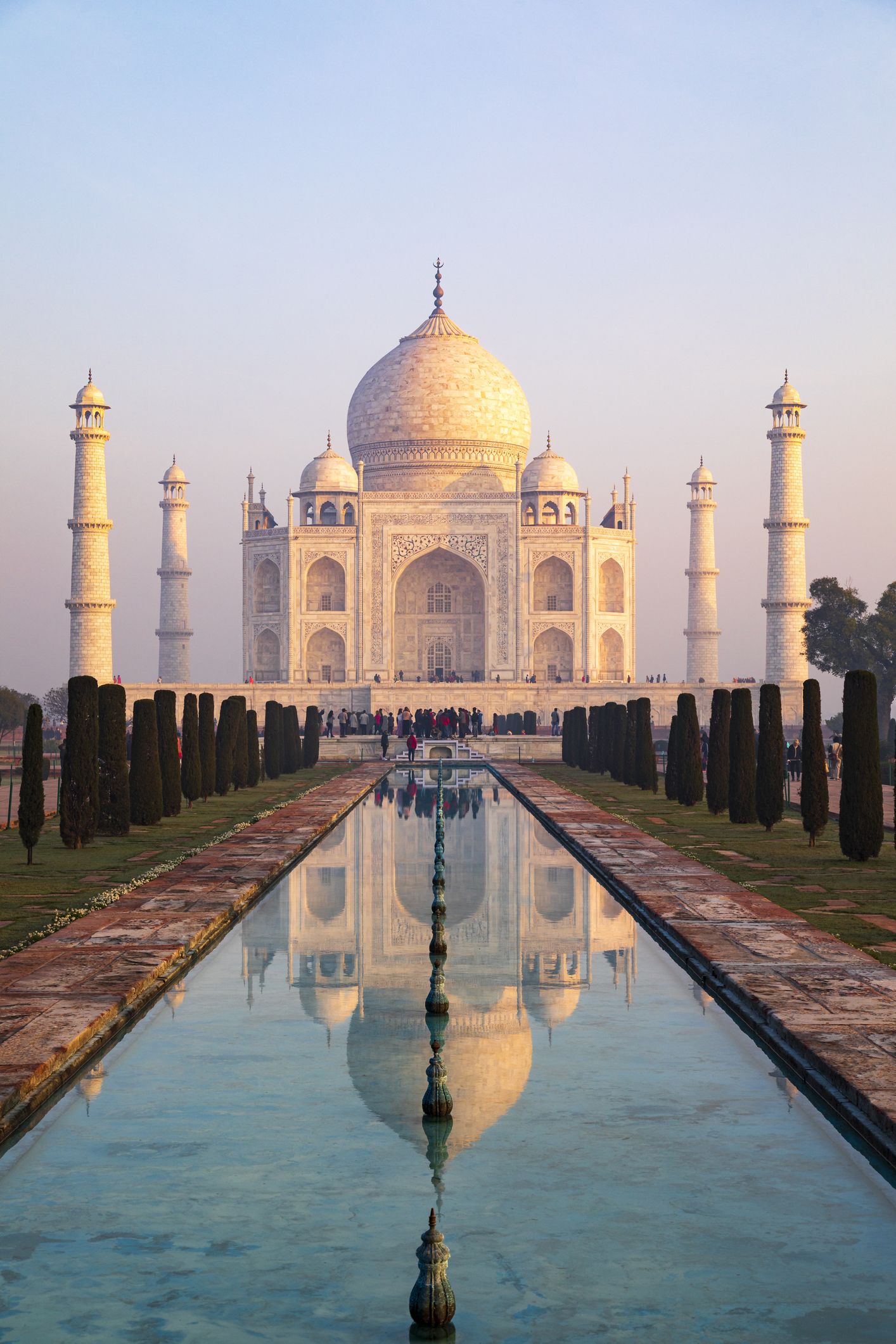 Captured in the early morning light, this image showcases the Taj Mahal as it's rarely seen, bathed in the warm glow of the rising sun
