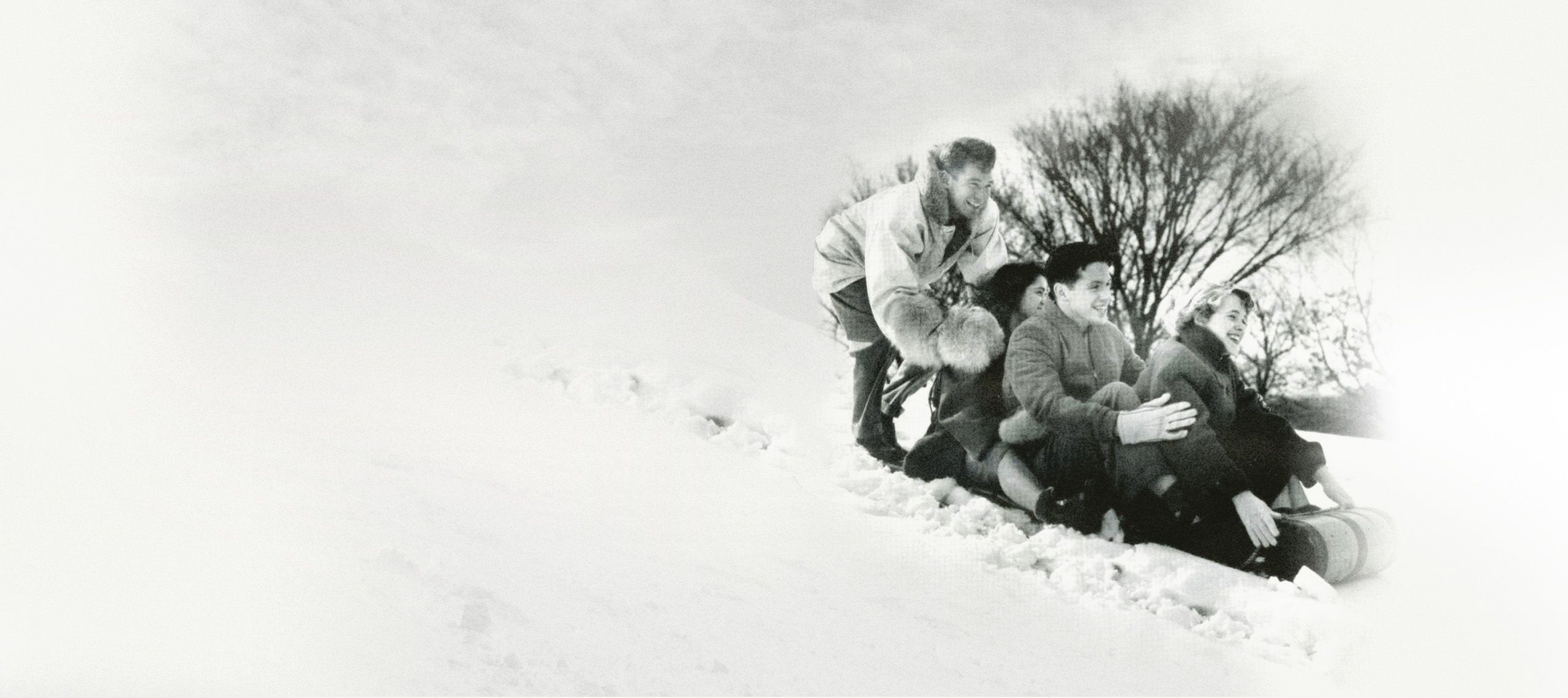 Purdue students sledding down a hill 